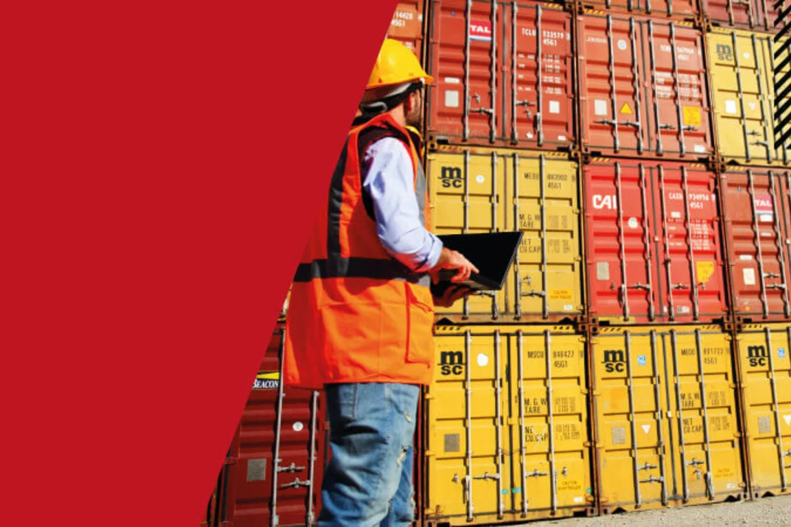 Banner image of man surveying shipping containers