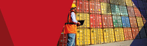 Banner image of man surveying shipping containers