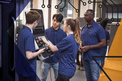 Group of apprentices using machinery in a factory setting, being overseen by a teacher. Make UK branded